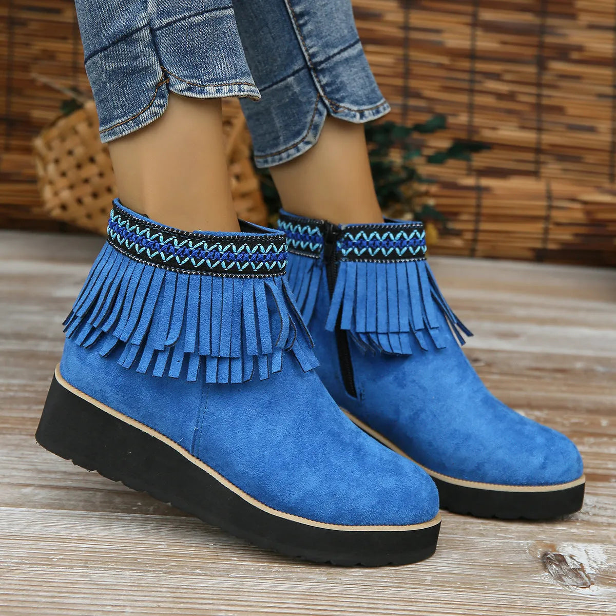 Women's dark brown suede wedge ankle boots with side zipper and tassel detail on a thick rubber sole.