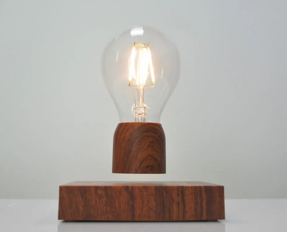 Magnetic levitation floating light bulb hovering above imitation wood base
