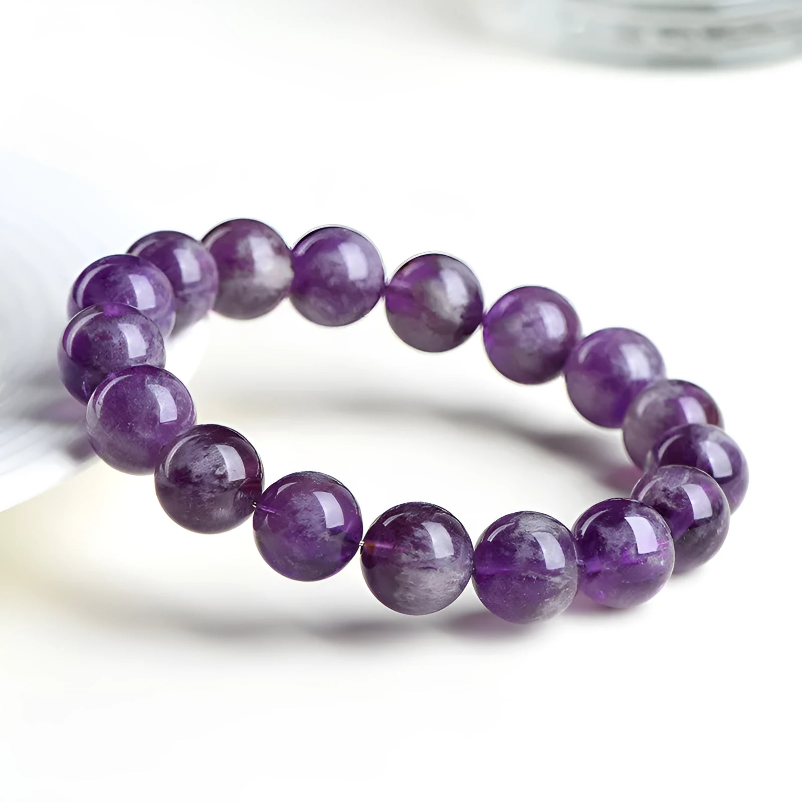 Natural feather amethyst crystal bracelet with scattered Snow Mountain purple beads and Ruyi detail.