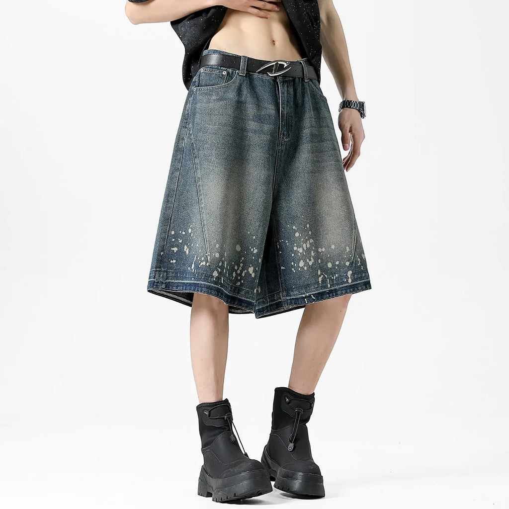 Retro blue denim shorts with distressed rip details and splash ink patterns, straight leg cut