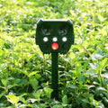 Green solar-powered ultrasonic dog and pest repeller unit for outdoor garden use.