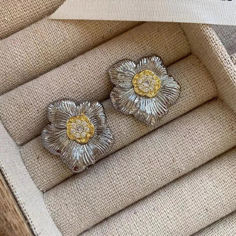 Retro textured two-tone copper stud earrings with gardenia petal motif on white background