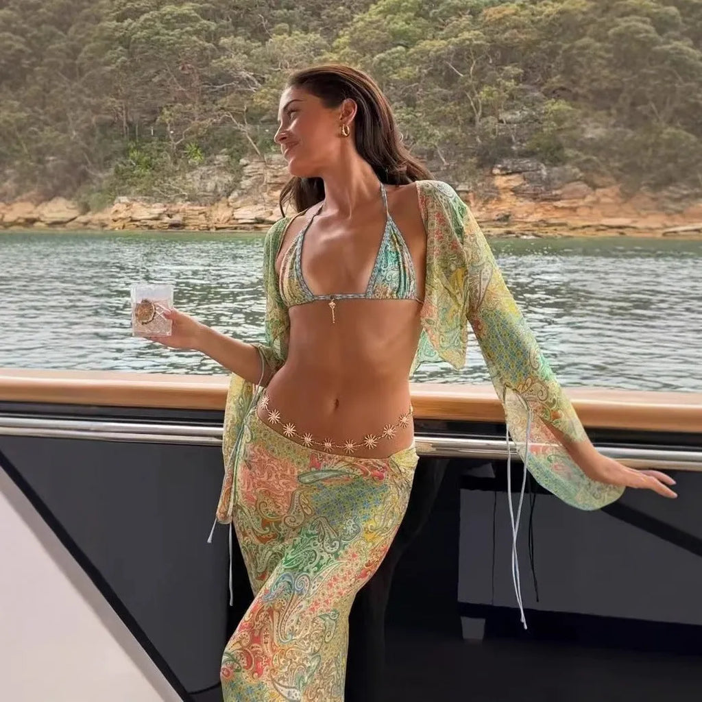 Green halterneck printed lace-up split swimsuit with long bell sleeves on model