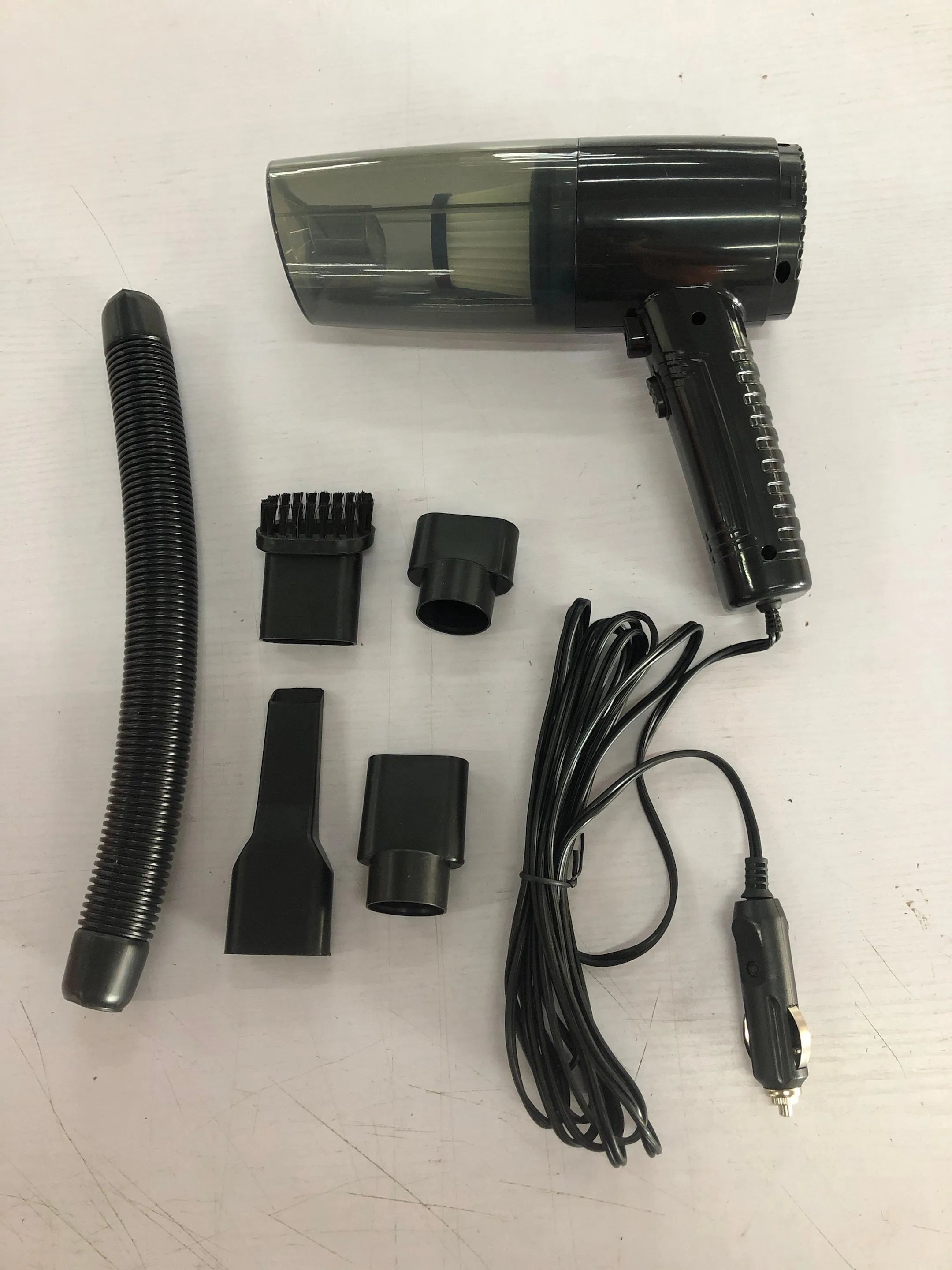 Black car vacuum cleaner with multiple accessory heads on 5-metre power cable