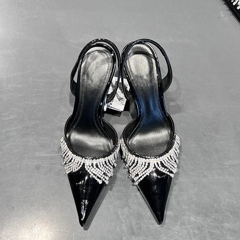 Black women's slingback high heel sandals with pointed toe, 10cm heel, and French tassel rhinestone detail.