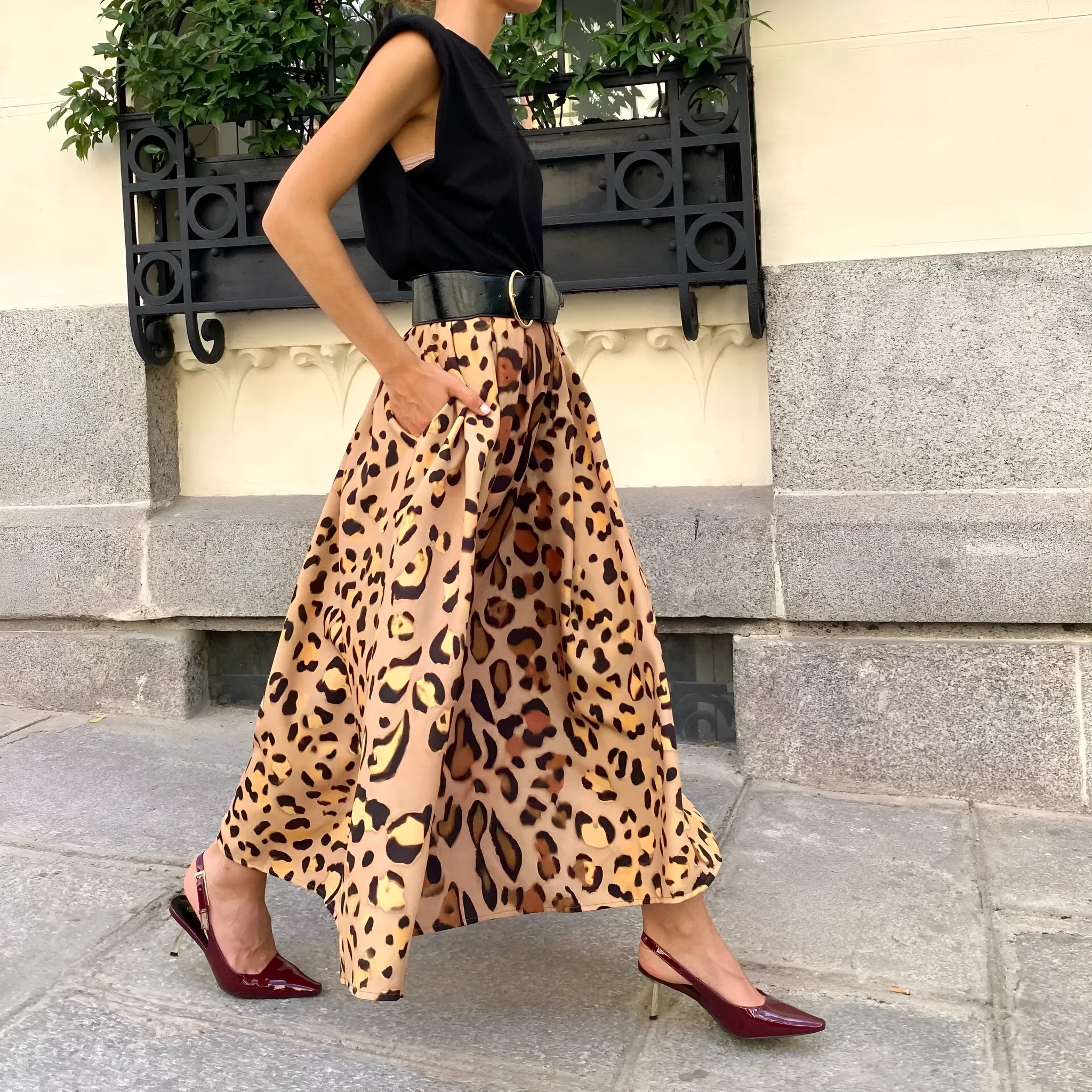 Brown leopard print women's A-line long skirt with big hem design on mannequin