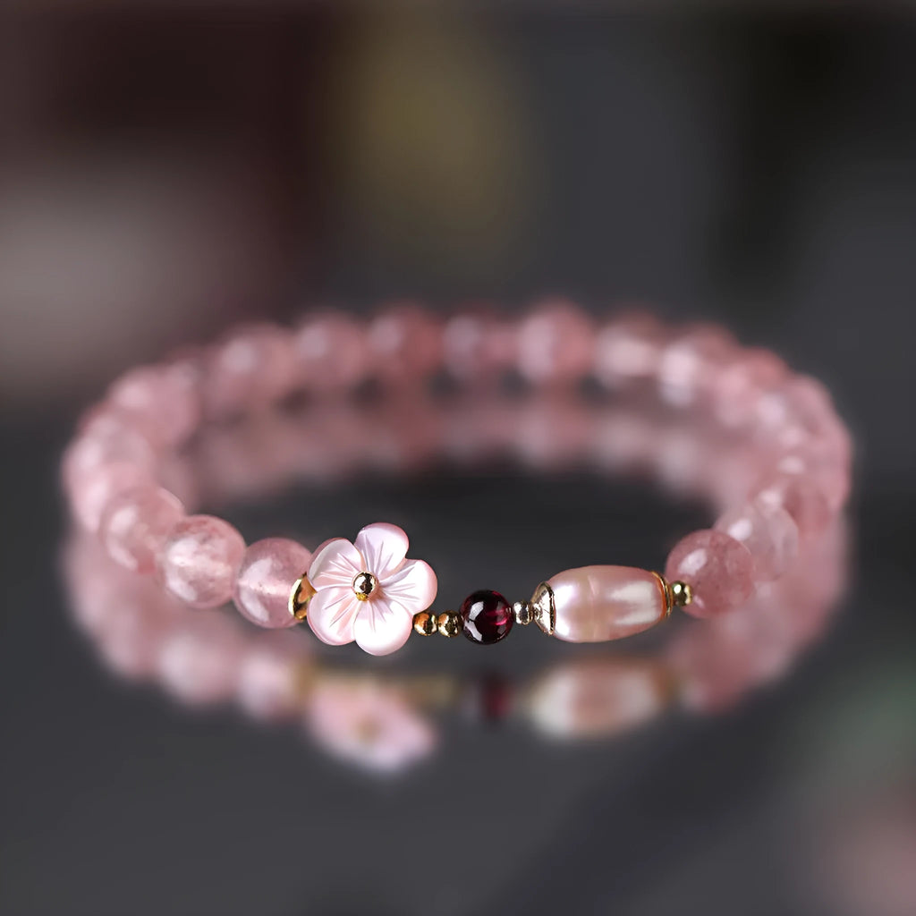 Strawberry quartz peach blossom crystal bracelet with floral design on wrist