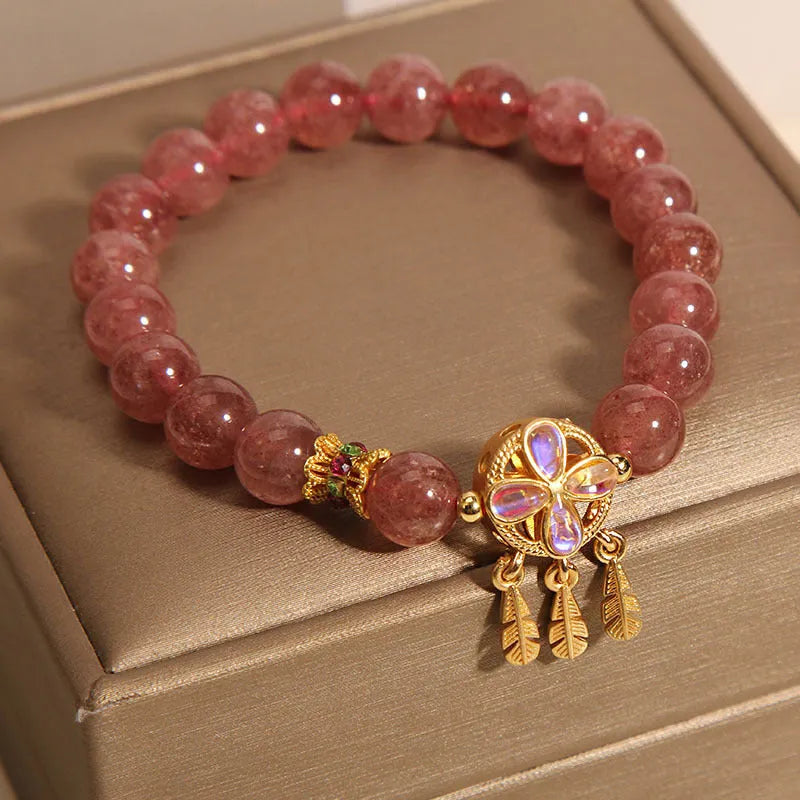 Women's strawberry quartz bracelet with four-leaf clover dream catcher ball pendant on adjustable leather cord