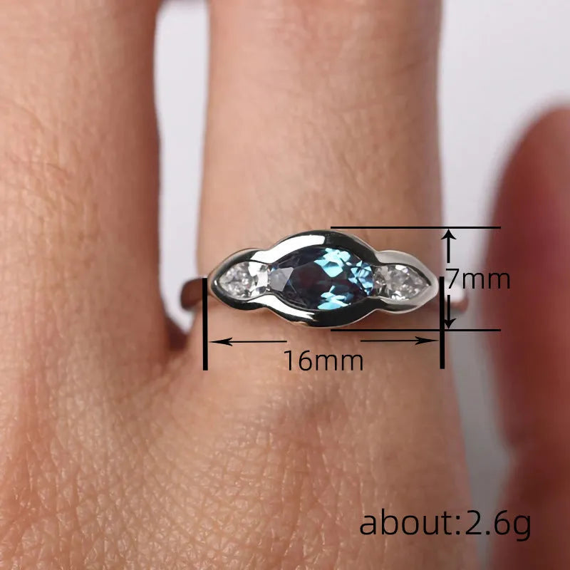 Women's geometric ellipse ring with inlaid zircon stones in white gold finish showing angular design details