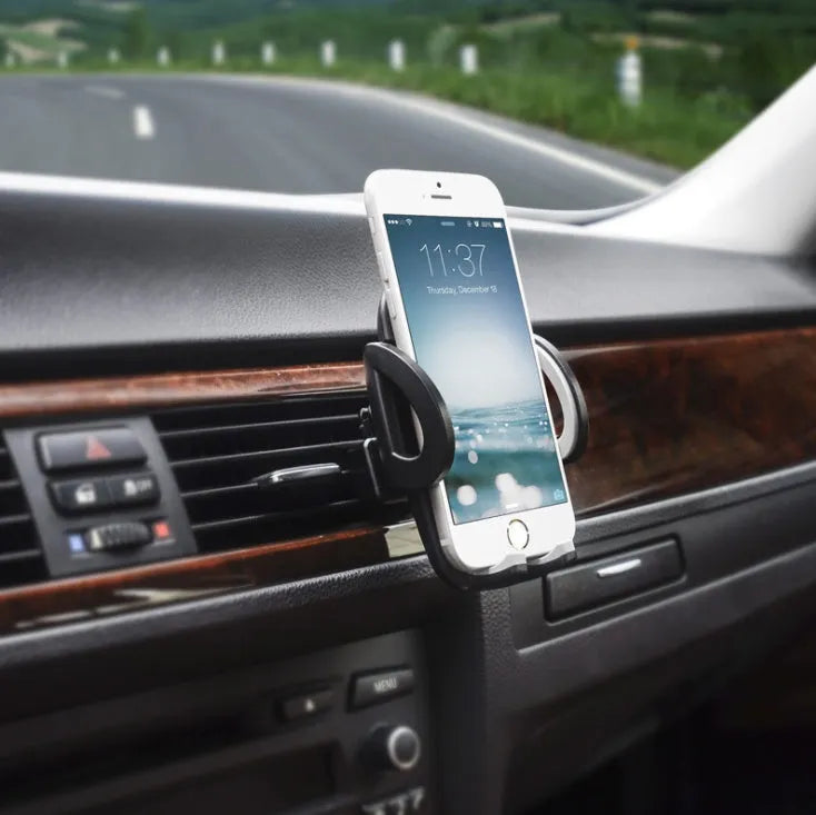 Black universal car mobile phone holder mounted on air conditioning outlet with smartphone secured