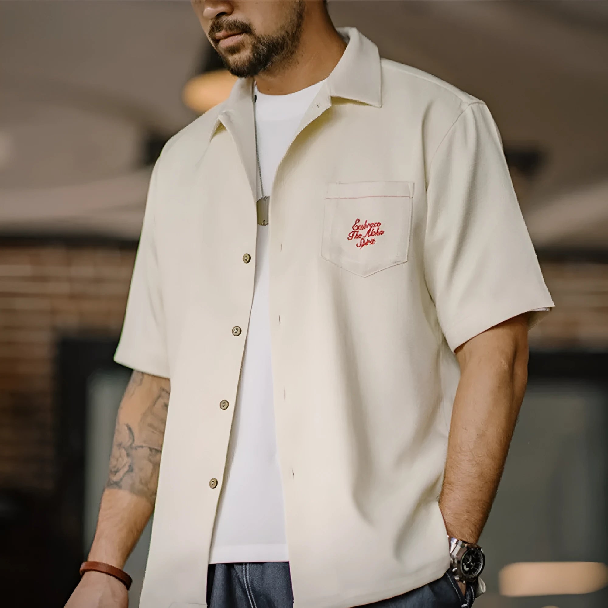Light apricot men's shirt with bamboo floral pattern and Cuban collar on hanger