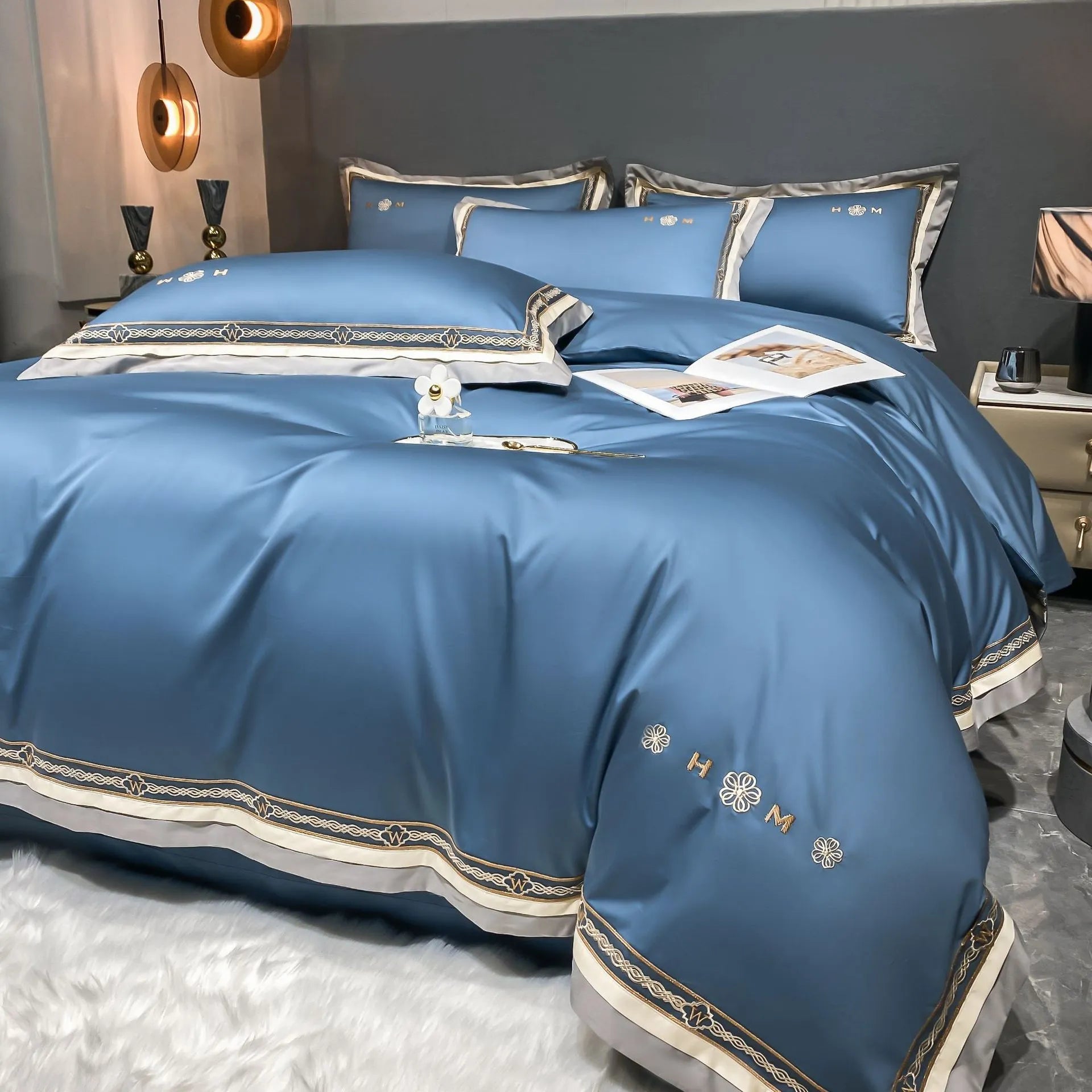 All-cotton light luxury four-piece bedding set with embroidery, available in multiple colours, on a bed