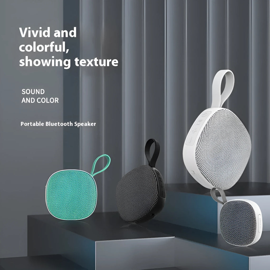 Wireless Bluetooth mini speaker with fabric waterproof cover and magnetic suction, available in black or white shell with grey or green cloth net