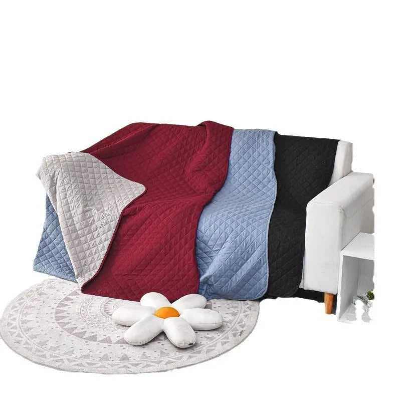 Waterproof reversible dog blanket on a sofa, showing two colour sides, with size chart for nine options.