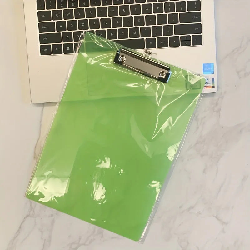 A4 transparent plate clipboard with metal clip, shown in blue colour on a desk with paper.