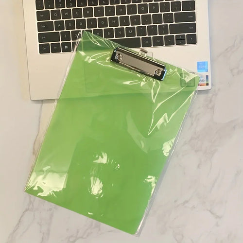 A4 transparent plate clipboard with metal clip, shown in blue colour on a desk with paper.
