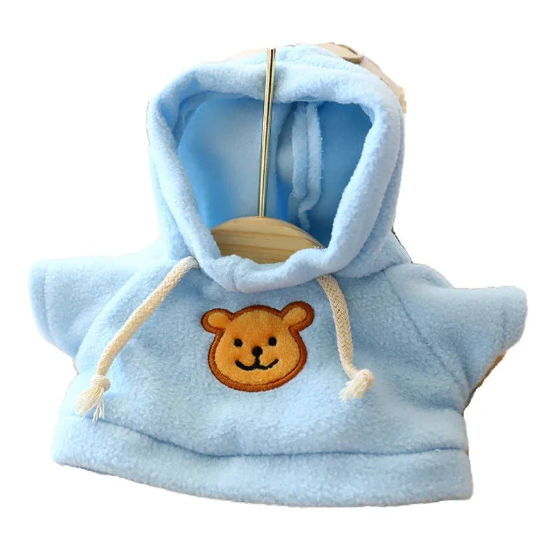 A dog wearing a blue cloth hoodie sweater, showing the casual hoodie style.
