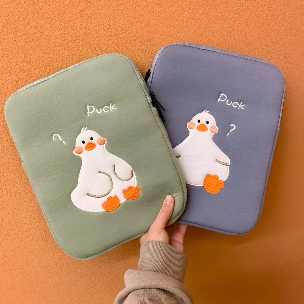 Blue cotton tablet case with embroidered cartoon duck design and zip closure