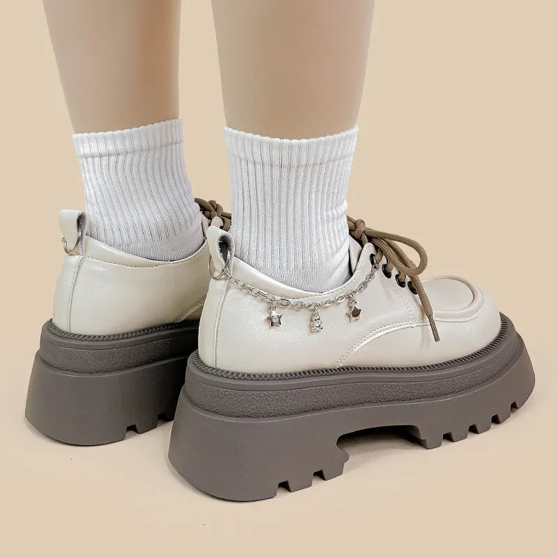 White PU platform Mary Jane shoes with thick chunky heel and front lace-up detail.