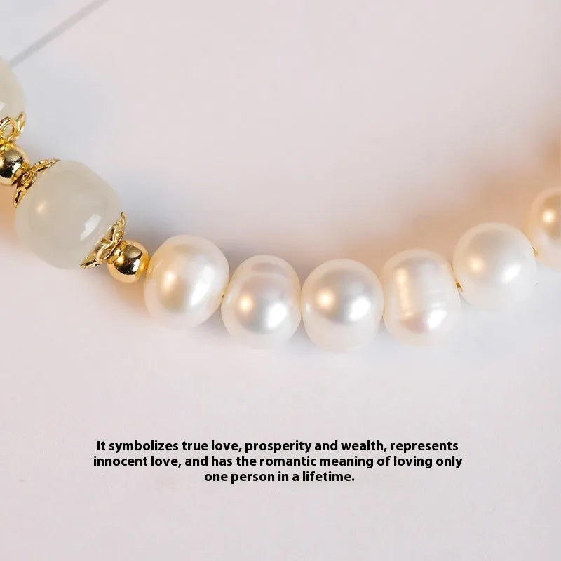 Korean style bracelet with diamond-shaped freshwater pearls in Hetian jade colour on a wrist.
