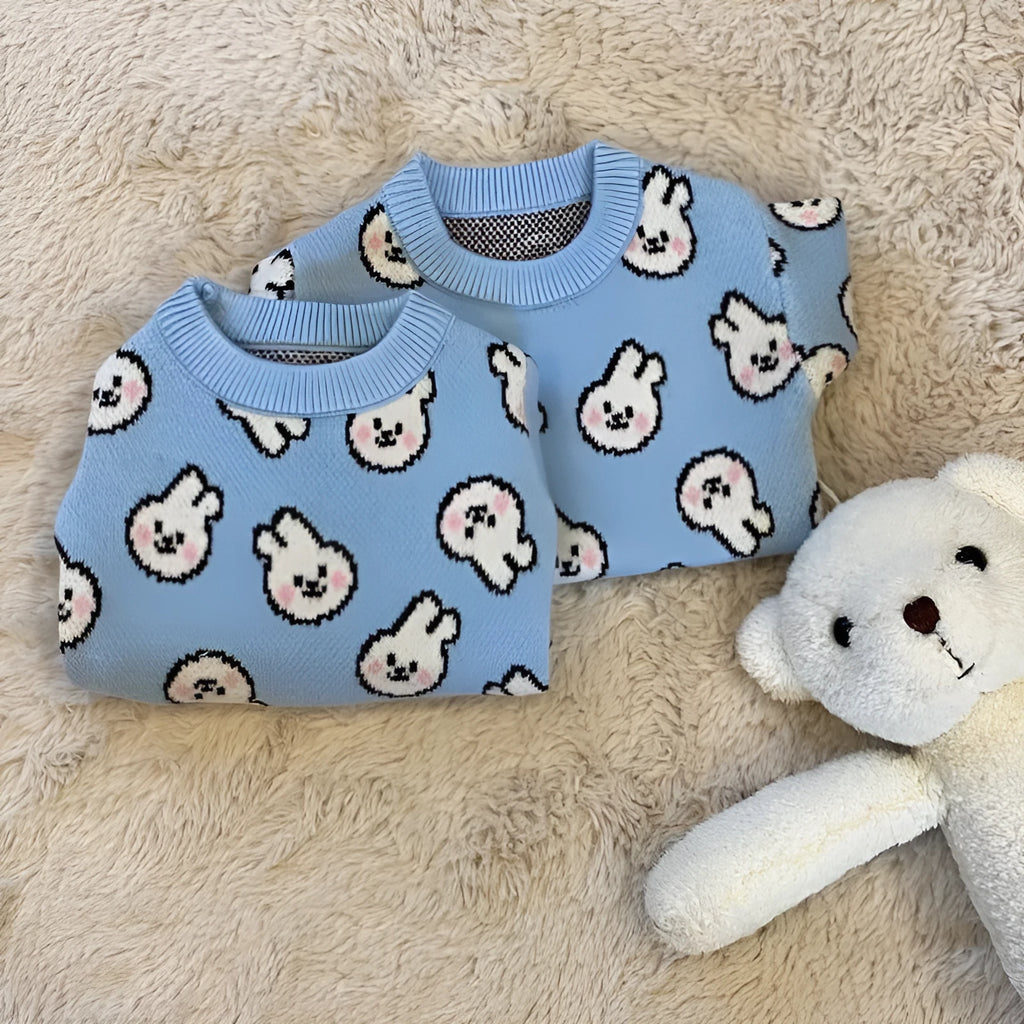 Small dog wearing a blue knitted sweater with charming pattern, warm soft polyacrylic material