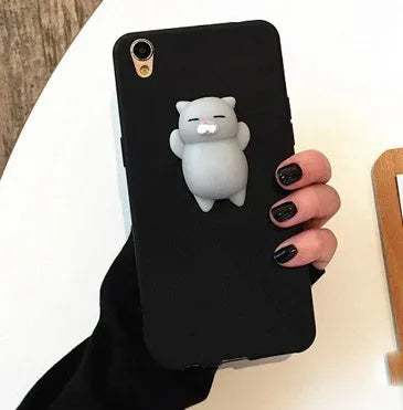Soft pink silicone iPhone case with a raised 3D cartoon cat design on the back.