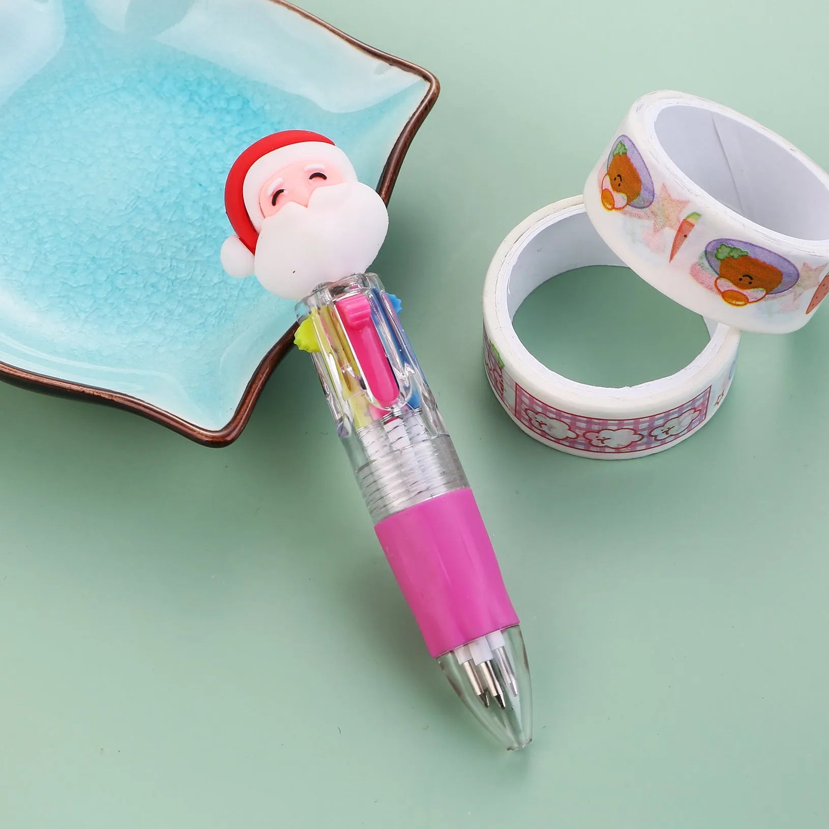 11cm long Christmas-themed four-colour ballpoint pen showing festive designs like reindeer and trees.