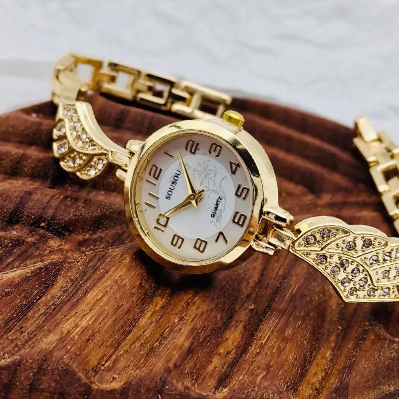 Women's stainless steel watch with round dial showing gold face colour option on wrist.