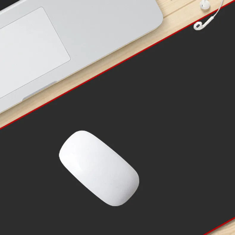 Solid colour black extra long overlock mouse pad on desk with keyboard and mouse