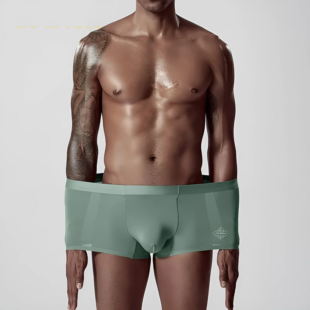 Seamless one-piece men's modal underwear in mid-waist design shown in green colour