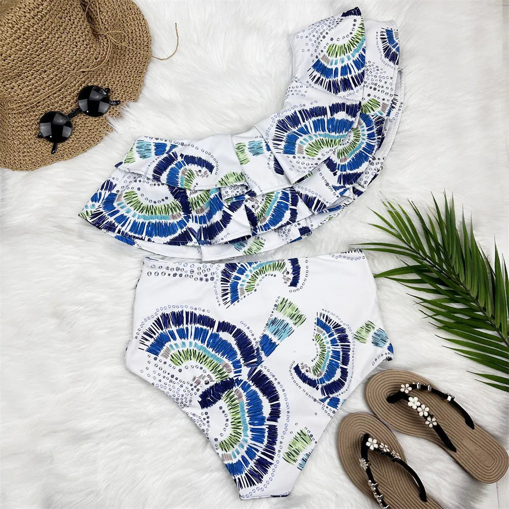 White women's one-shoulder swimsuit with a large decorative lotus leaf layer on the front.