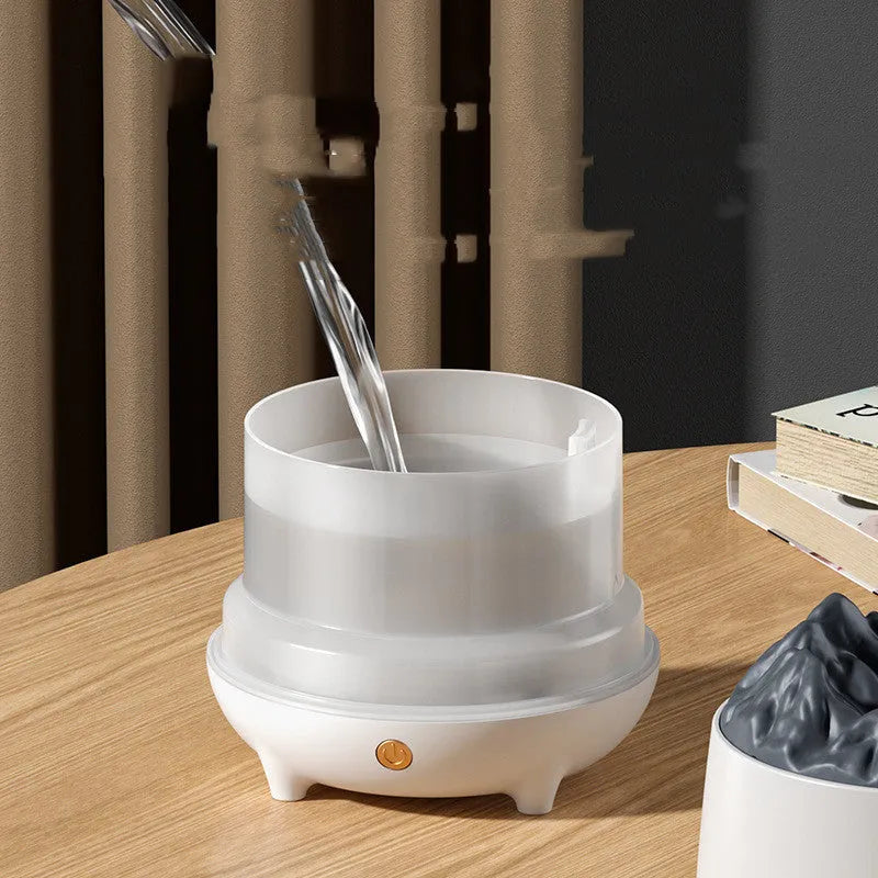 White or black volcano-shaped ultrasonic humidifier with USB cable for rooms up to 20 square metres.