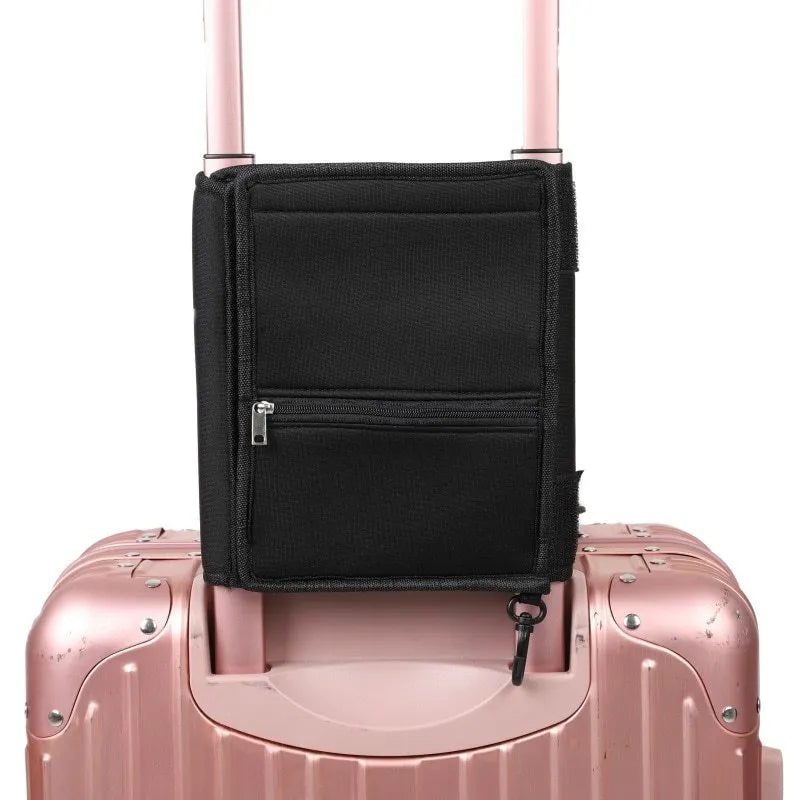 Black canvas large capacity packing tote folded flat on a surface, showing its storage pouch design