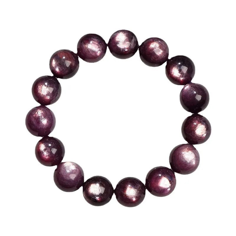 Close-up of a handcrafted purple lepidolite crystal bracelet with polished round beads on a wrist.