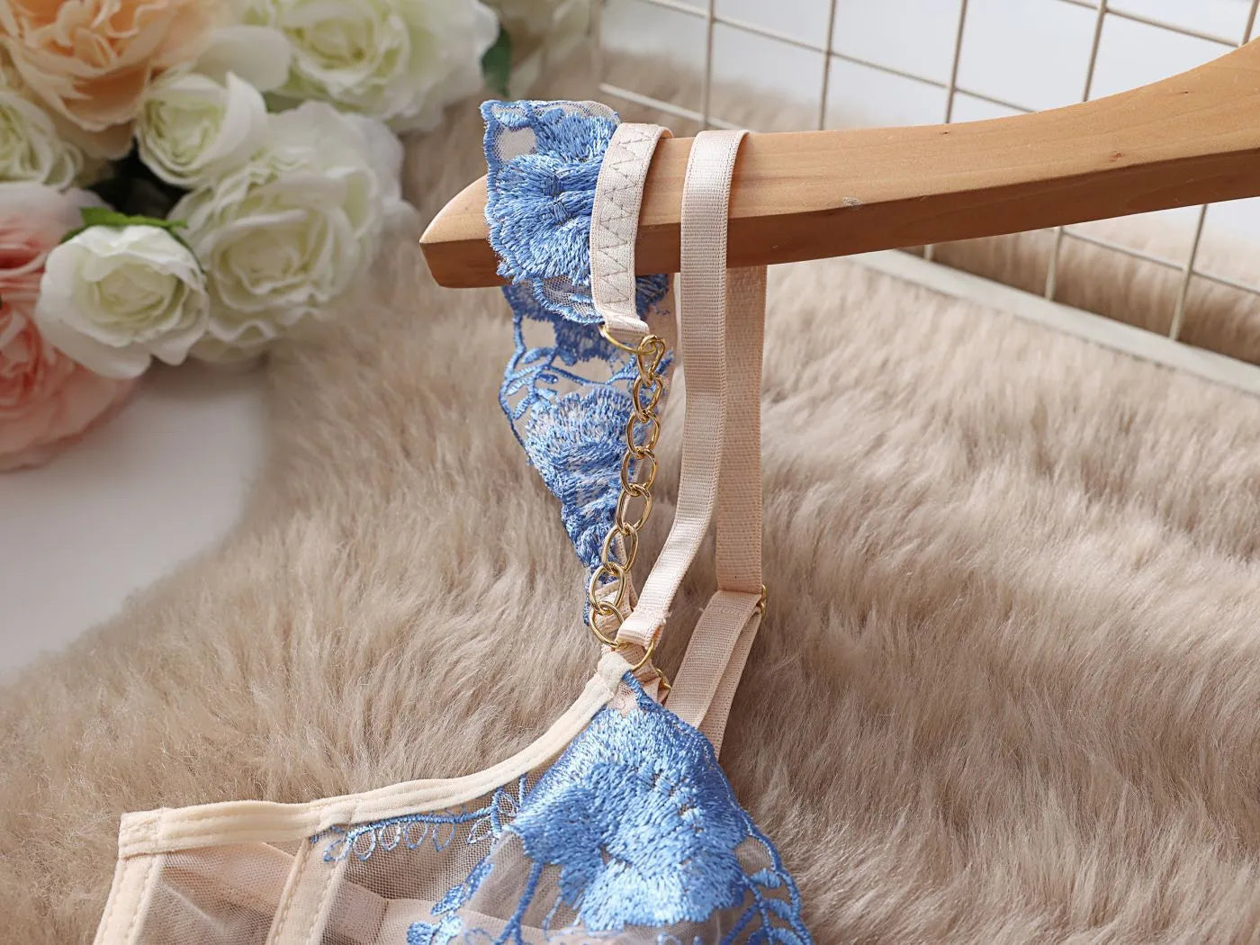 Light blue embroidered lace push-up bra and mesh pants lingerie set on a neutral background.