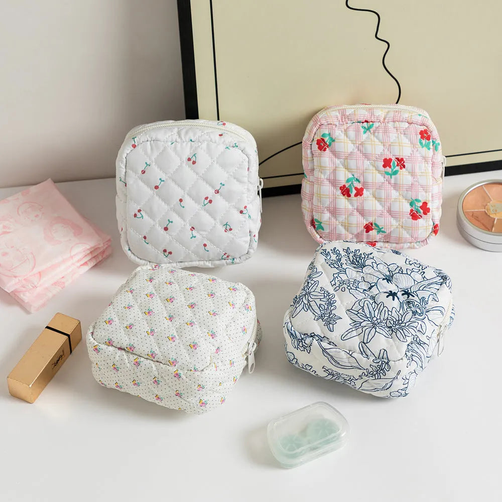 Small floral polyester key storage wallet with sewing thread detail in multiple colour patterns.