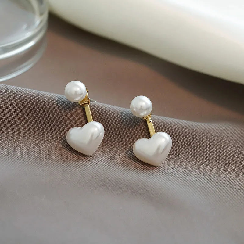 Korean style heart-shaped alloy stud earrings for women with artificial gem inlay on a white background.