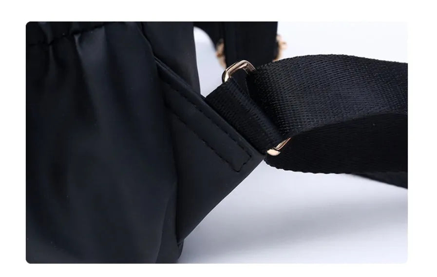 Black waterproof Oxford backpack for women, 34cm high, showing front view on plain background