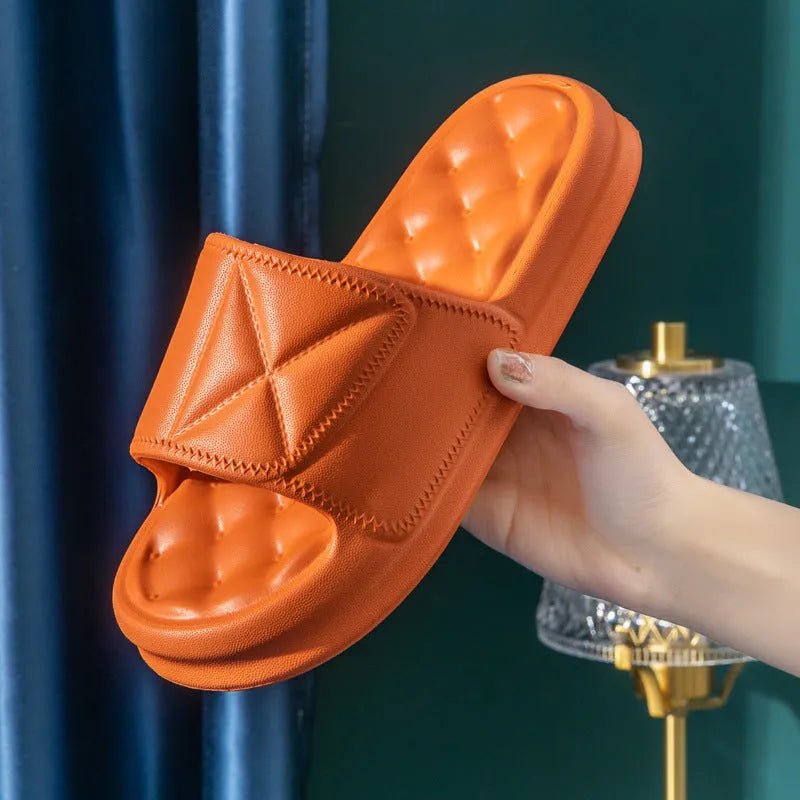 Unisex thick sole EVA bathroom slippers in black, shown on a wet tile floor.