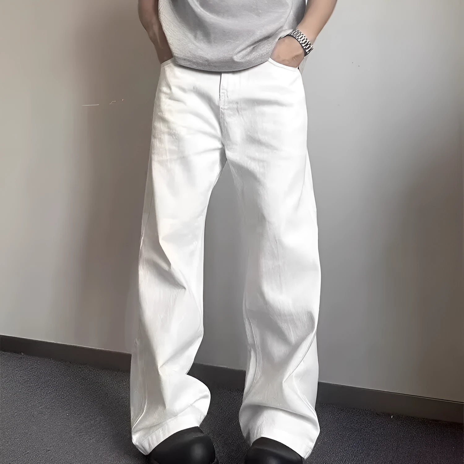 Men's white loose fit wide-leg straight denim jeans on a mid-waist model.