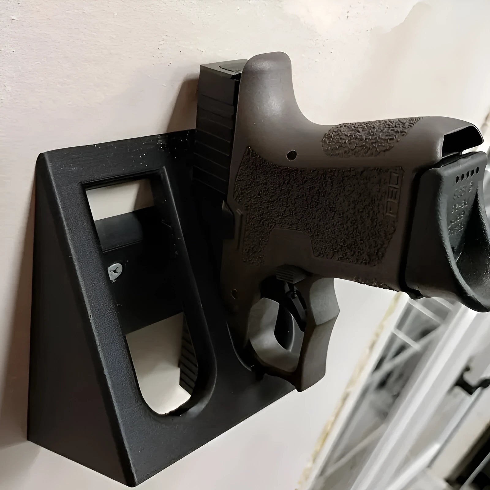 Black punk-style plastic pistol display stand for replica firearms