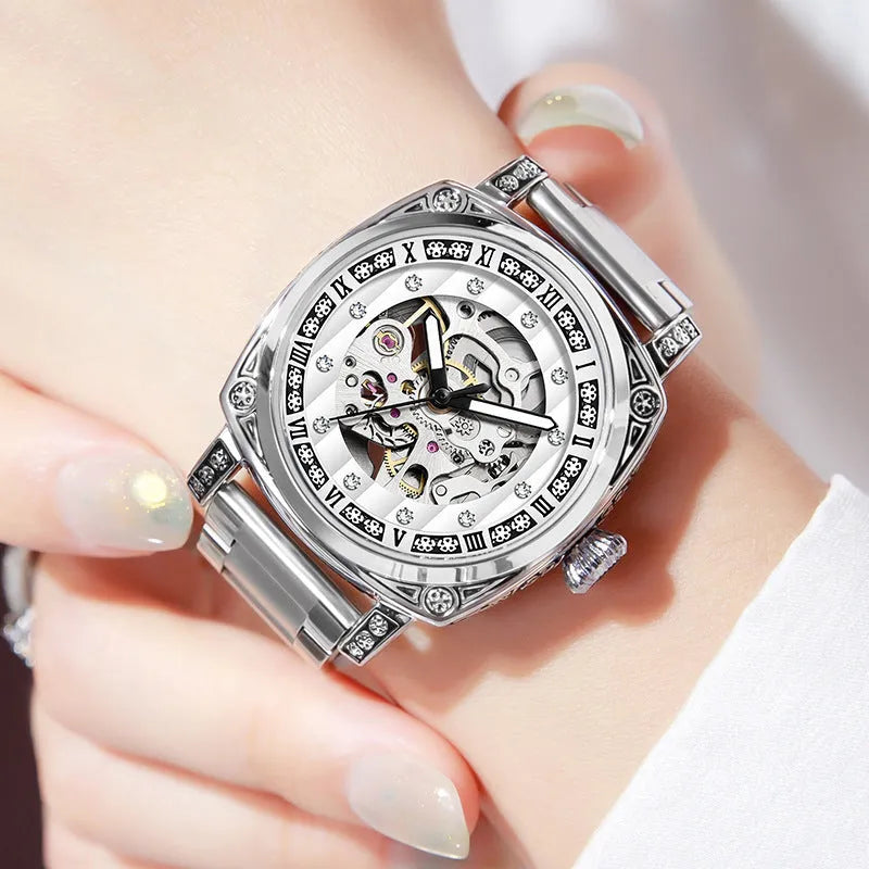 Mechanical watch with luminous hands on a leather strap, shown in black, red, steel, and white colour options.