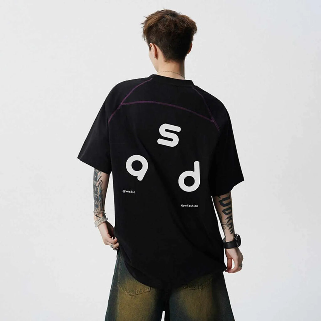 Men's loose-fit black cotton t-shirt with a white printed letter design on the front, showing short sleeves and a round neck.