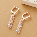 A pair of rectangular two-tone hollow stud earrings with a geometric design and electroplated alloy finish.