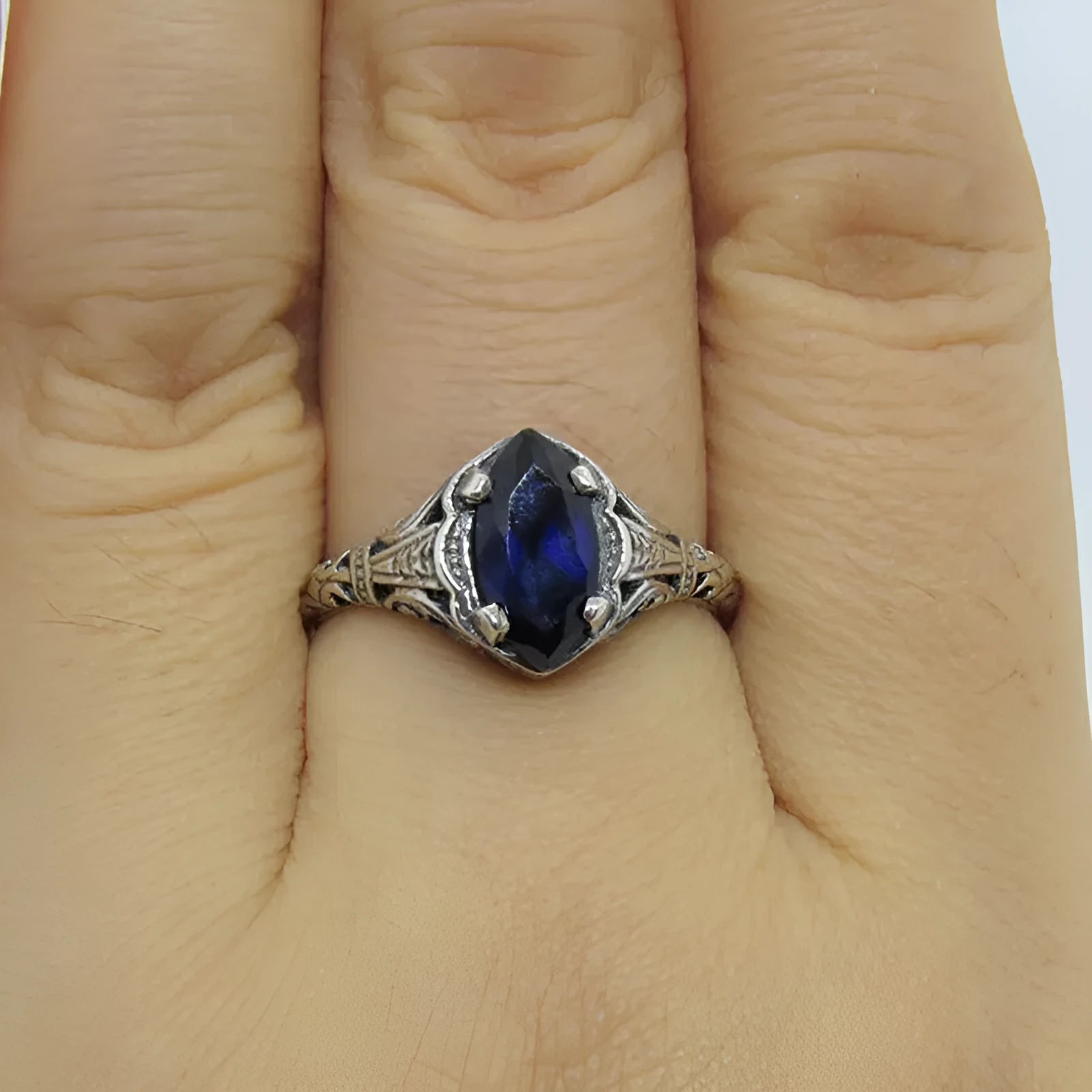 Women's silver geometric hollow-out alloy ring showing detailed pattern and zircon elements