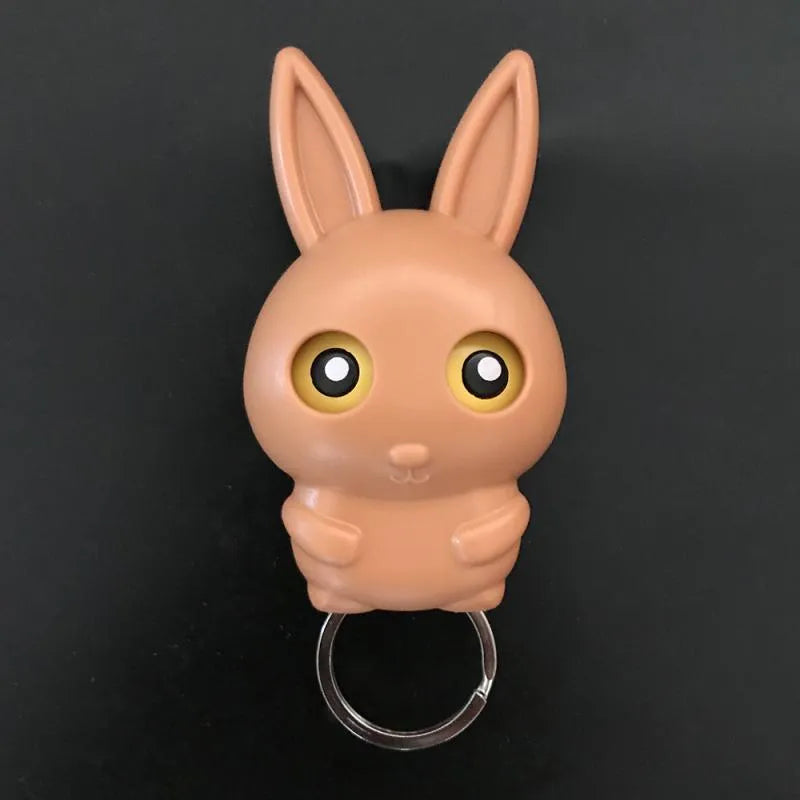 Magnetic wall key holder in white with attached keychains on a wall surface