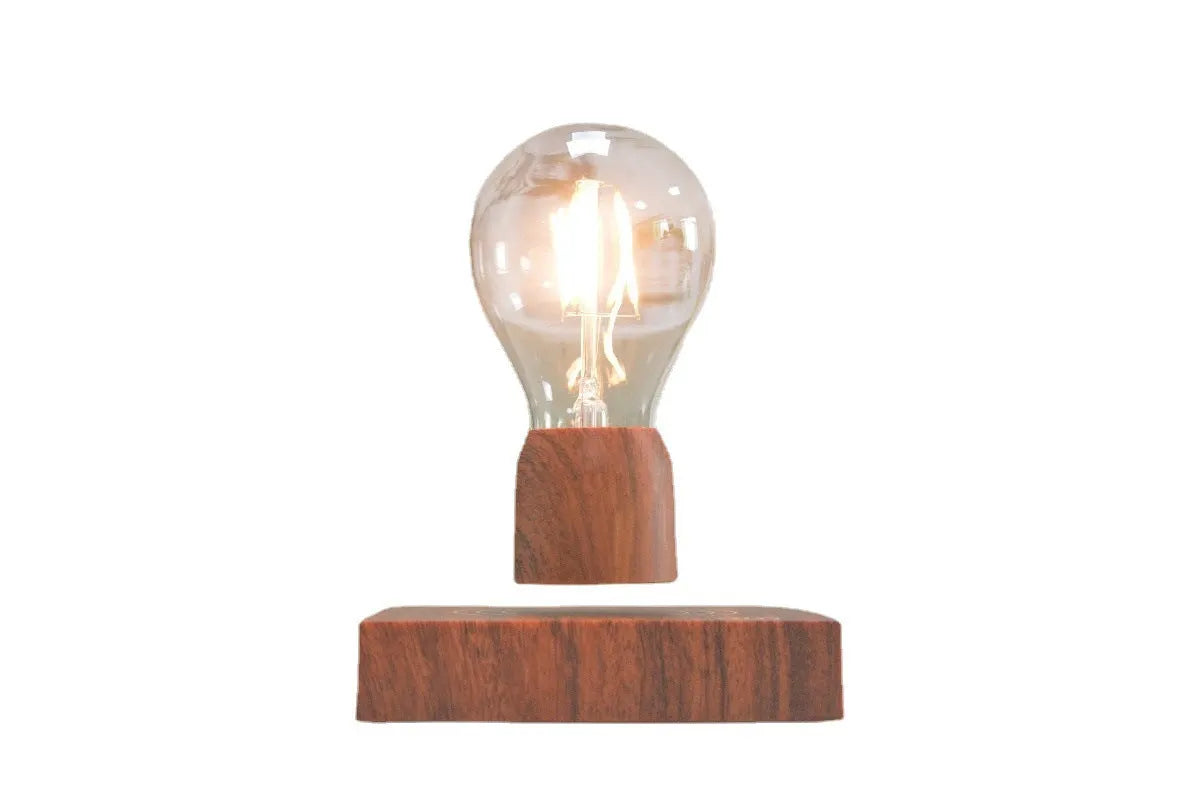 Magnetic levitation floating light bulb hovering above imitation wood base
