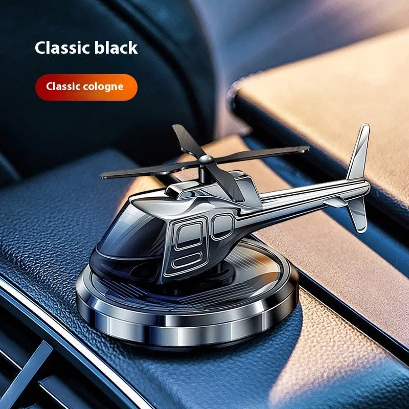 Silver solar-powered metal helicopter car ornament with rotating blades and air freshener function.