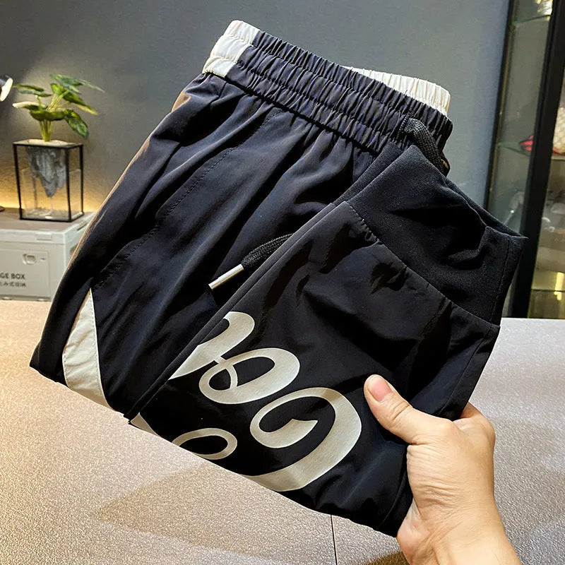 Man wearing black ultra-thin ice silk cropped trousers with elasticated ankle bands.