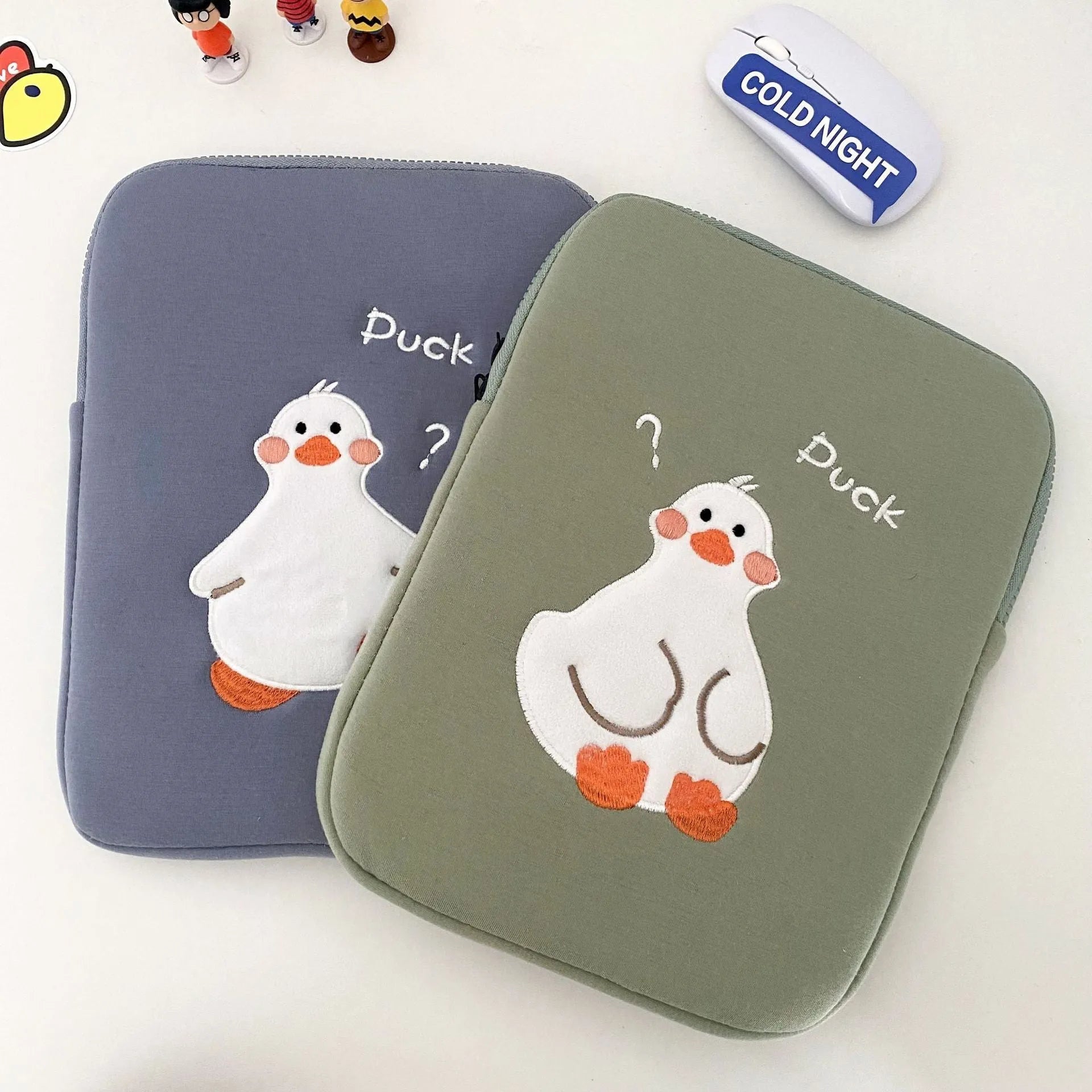 Blue cotton tablet case with embroidered cartoon duck design and zip closure